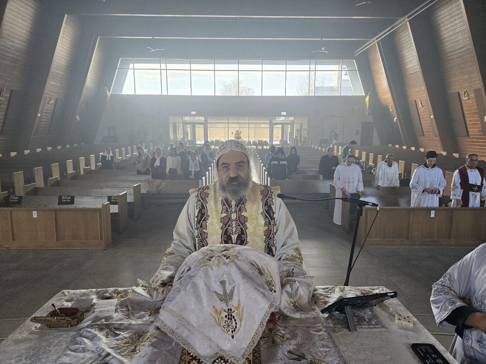 Priest praying at the altar